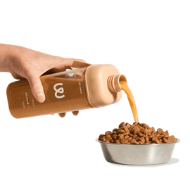 doggy broth bottle pouring into dog food